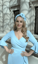 Katya in a pale blue dress and fascinator